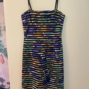 Strapless cocktail dress in multi colored fabric with black mesh liner